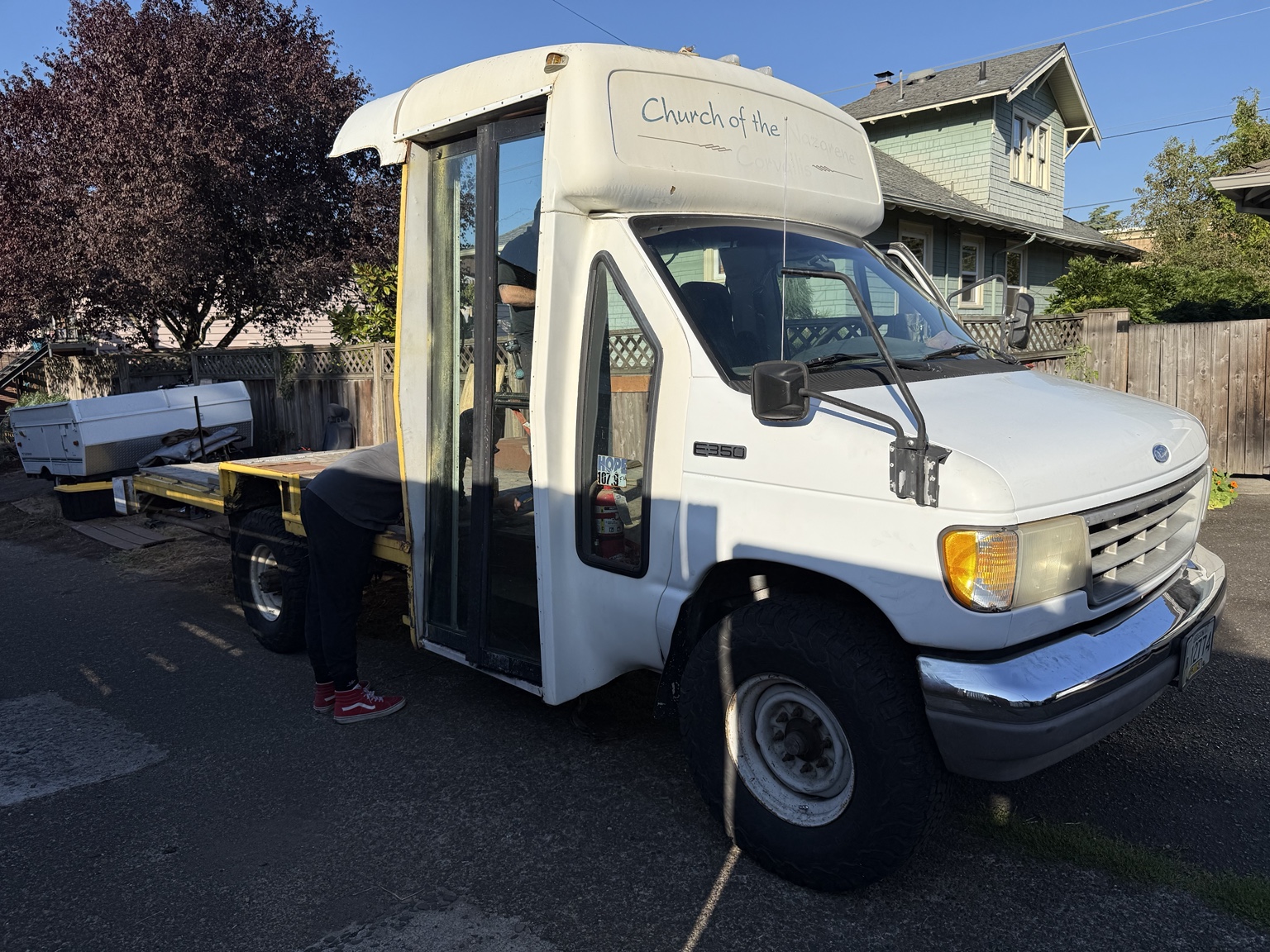 Buck's white cab and flatbed in a driveway