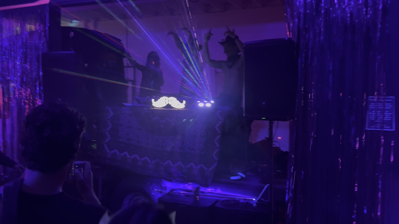 purple stage lighting and laser beams at the party