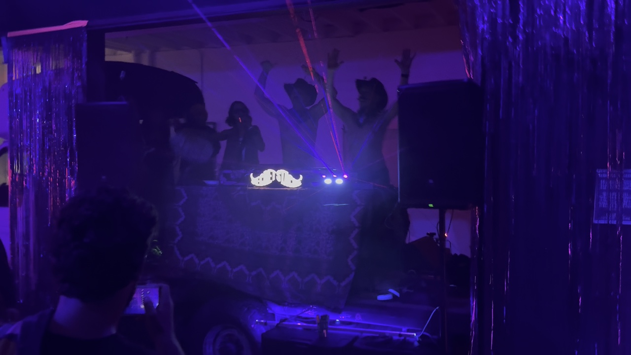 Wide view of DJs playing on Buck as a stage at a previous party